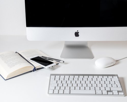 A professional woman doing gentle wrist extensions at her office workstation