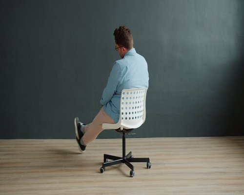 Close up of a person adjusting their home office chair for better posture support